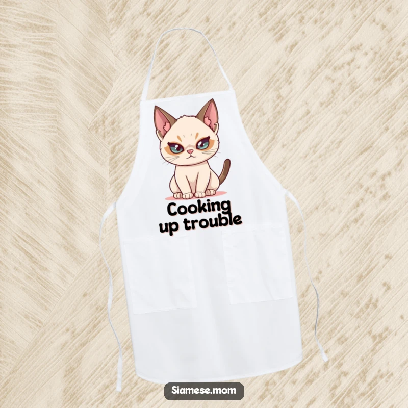 Funny Siamese cat apron, showing a mischievous cat with a twinkle, great for adding fun to kitchen tasks.