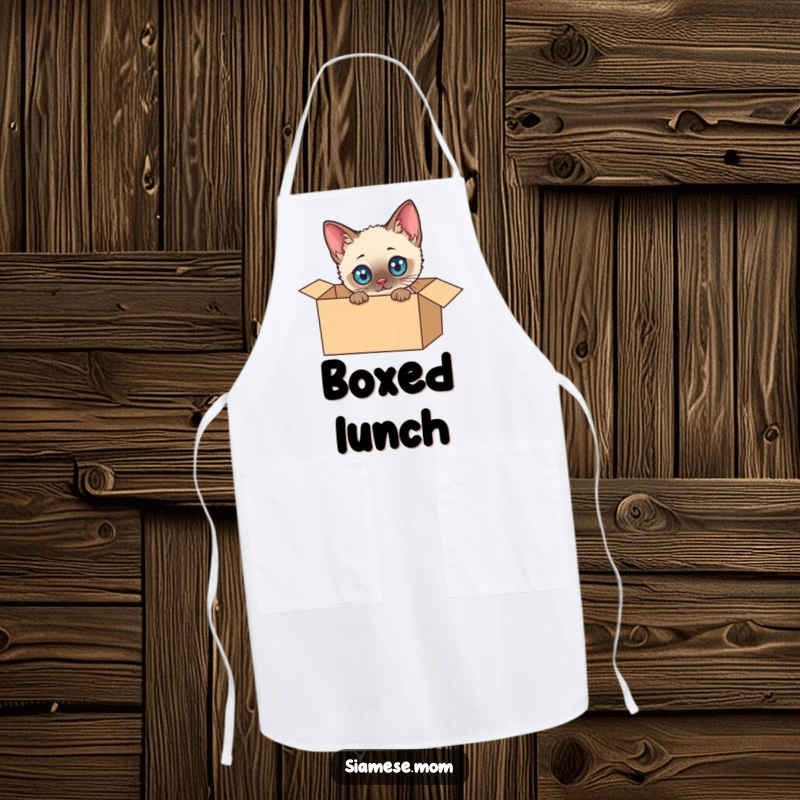 Funny Siamese Cat Apron: Cute kawaii cat peeking from a cardboard box, ready for kitchen adventures, adding humor to cooking.