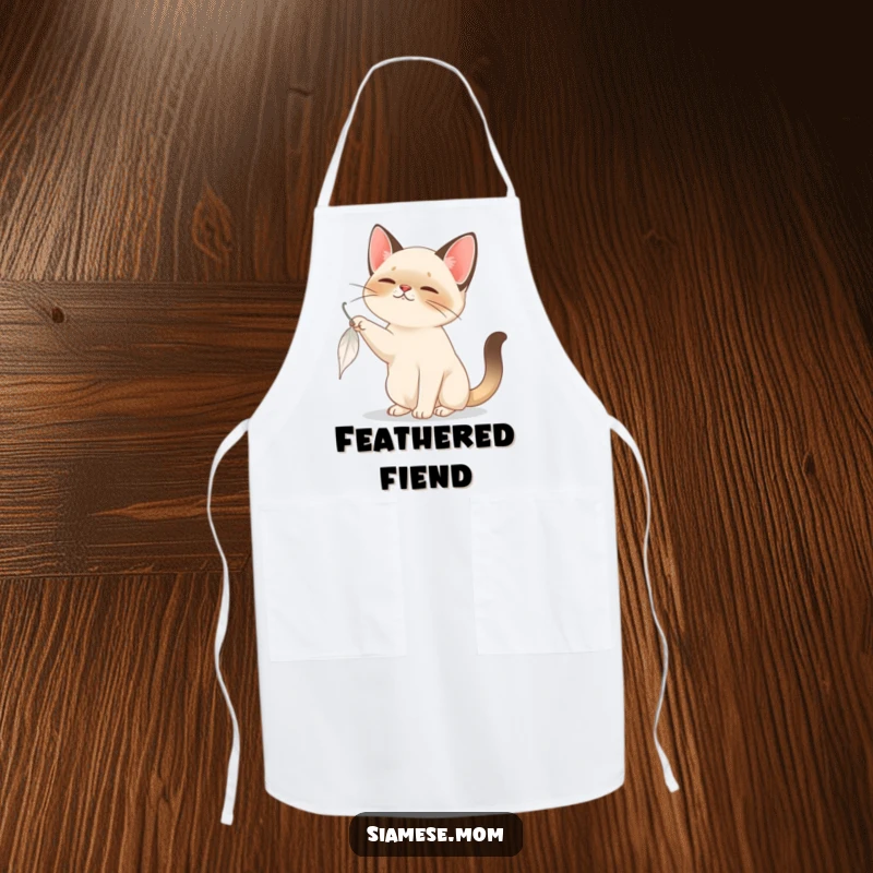 Funny Siamese Cat Apron: A playful Siamese cat bats at a feather while you cook, adding a humorous element to the kitchen.