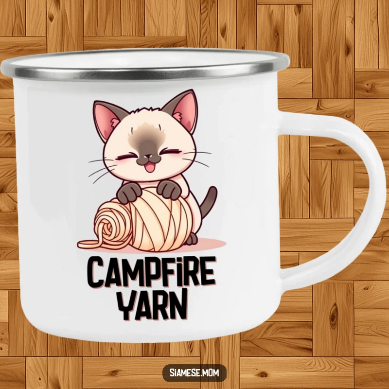 Funny Kawaii Siamese cat camping mug, playful smirk, pouncing on a rolled-up ball of yarn, ready for campfire fun and laughter.