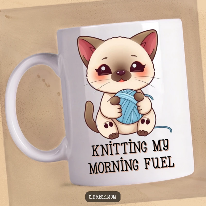 Funny mug with a kawaii Siamese cat playfully holding a ball of yarn, perfect for cat lovers who enjoy cute mischief.