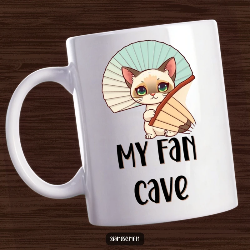Funny Siamese Cat Mug: A mischievous cat peeks adorably from behind a large fan, expressing playful curiosity and a desire for cool.
