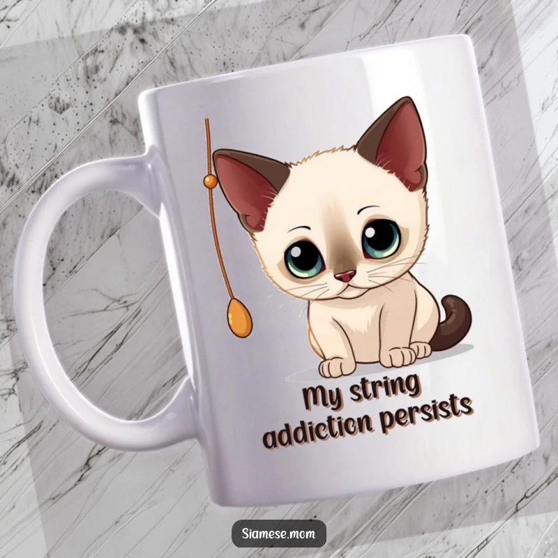 Funny Siamese Cat Mug: Wide-eyed kitty playfully batting at a dangling string, full of curiosity and mischief.