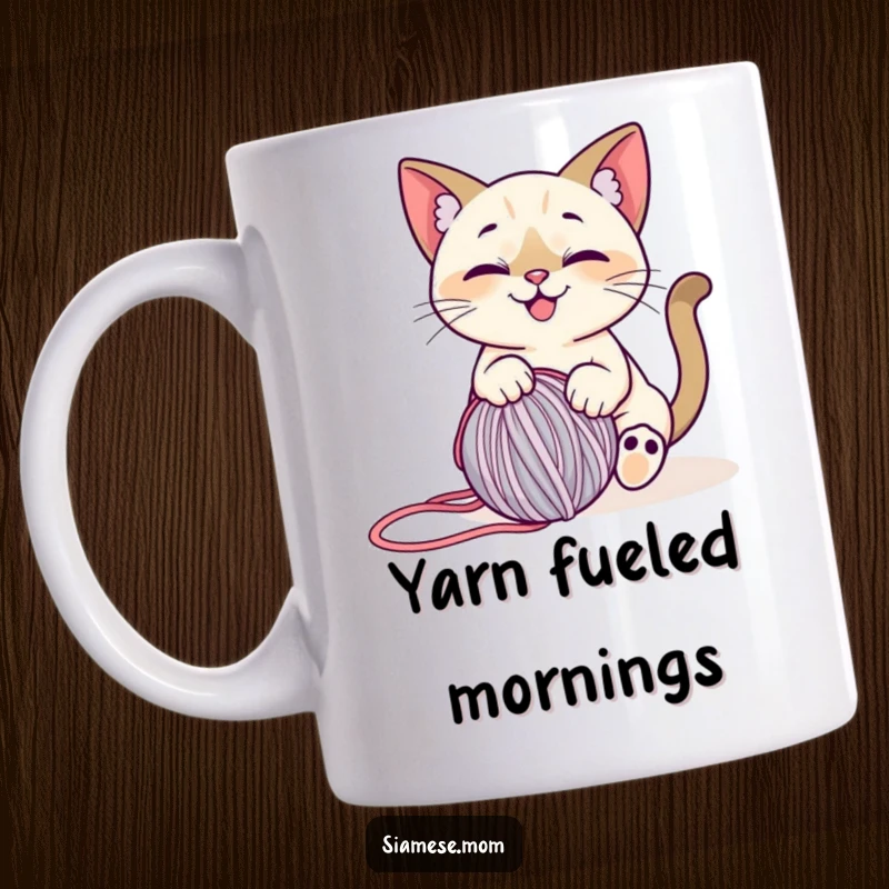 Funny Siamese Cat Yarn Mug: A stylized, smiling cat playfully batting at a rolling ball of yarn, full of joy.