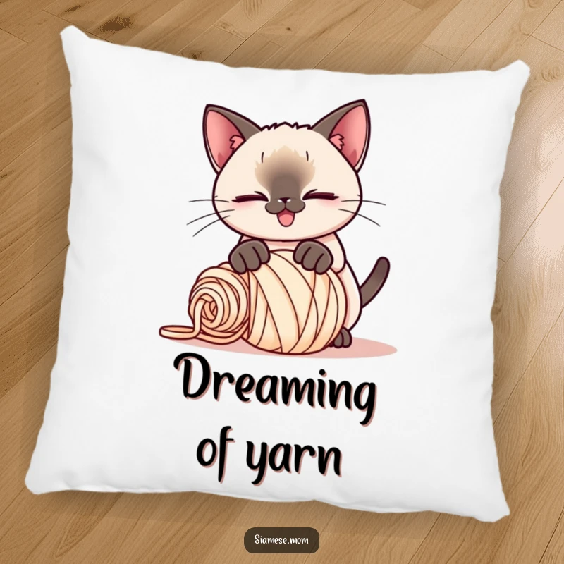 Funny Kawaii Siamese cat pillow, playful smirk, pouncing on a rolled-up ball of yarn, a soft and humorous accent piece.