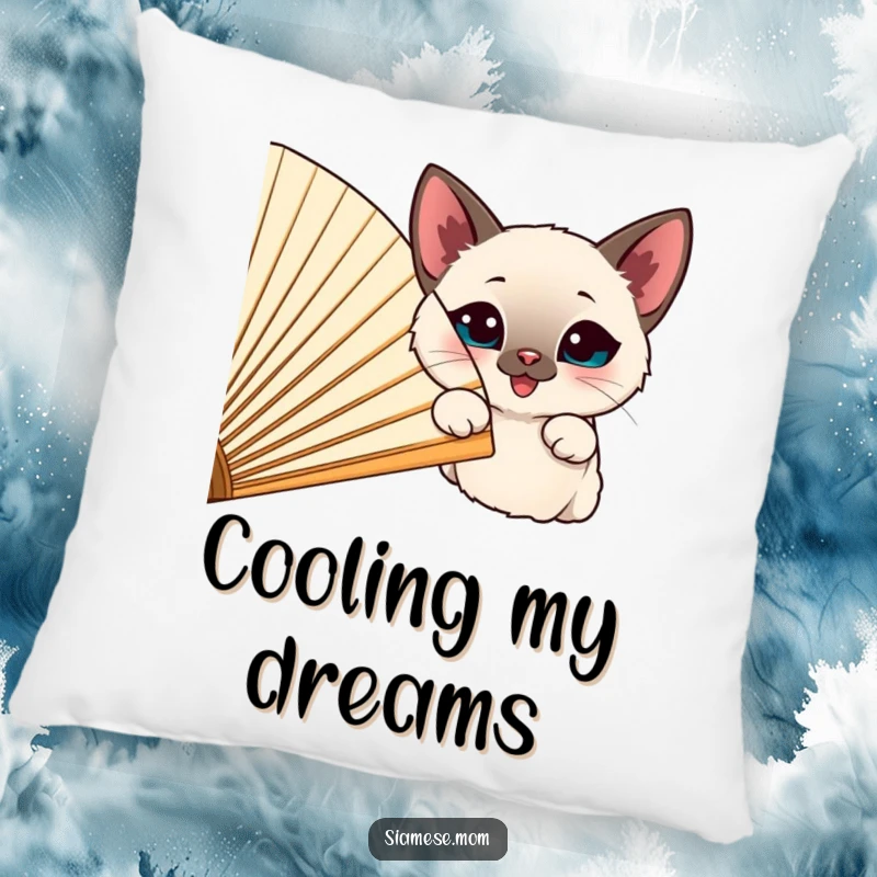 Funny happy Siamese cat peeking from behind a large, cheerful fan, depicted on a soft decorative pillow.