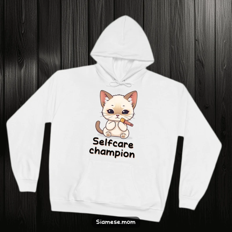 Funny Kawaii Siamese cat hoodie illustration of a cat carefully grooming itself with a tiny brush and looking pristine.