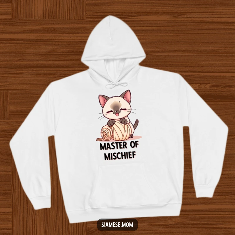 Funny Kawaii Siamese cat hoodie, playful smirk, pouncing on a rolled-up ball of yarn, soft and humorous attire.
