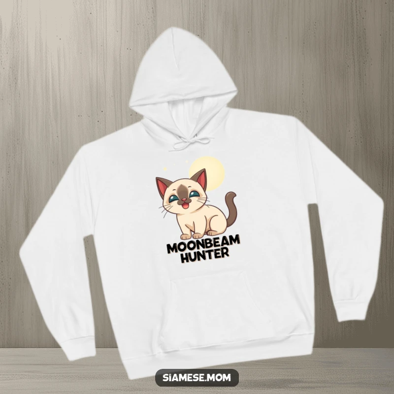 Funny stylized Siamese cat happily batting at glowing moonbeams, featured on a warm hoodie.