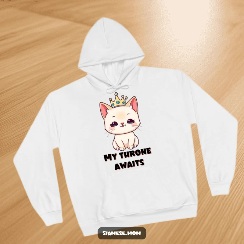 Funny hoodie featuring a kawaii Siamese cat adorned with a small crown, exuding regal satisfaction.