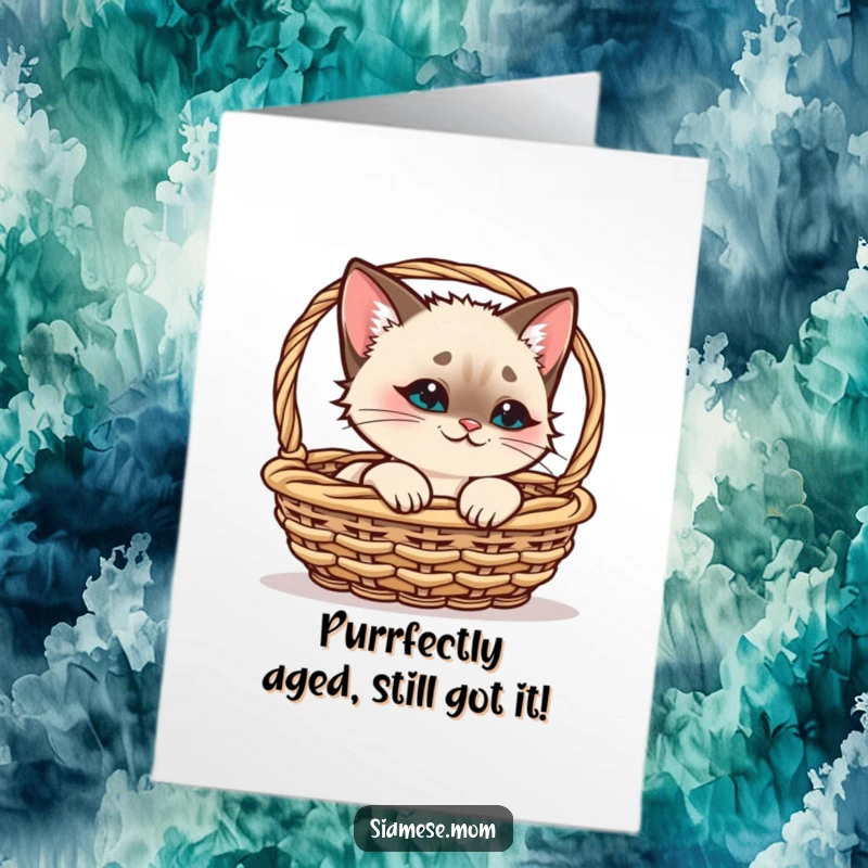 Funny Free Printable Birthday Card: Kawaii Siamese cat with a playful smirk peeking from a basket, ready to celebrate.