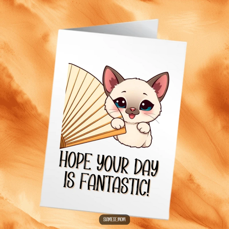 Funny Free Printable Birthday Card, a happy Siamese cat peeking playfully from behind a large, cheerful fan.