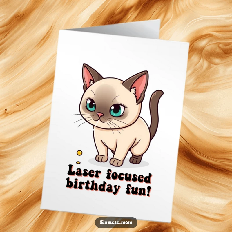 Funny Free Printable Kawaii Siamese Cat Birthday Card chasing a laser dot with intense focus, a downloadable gift.
