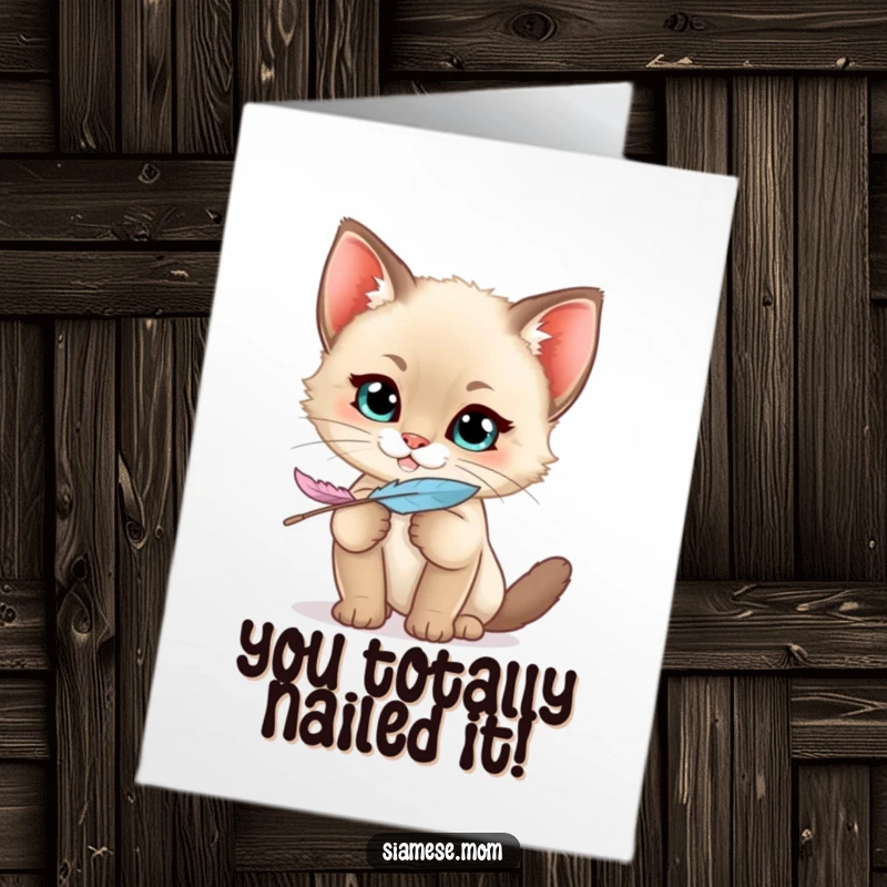 Funny Free Printable congratulations card: A mischievous kawaii Siamese kitten with a cheeky grin clutches a feather, celebrating your success.
