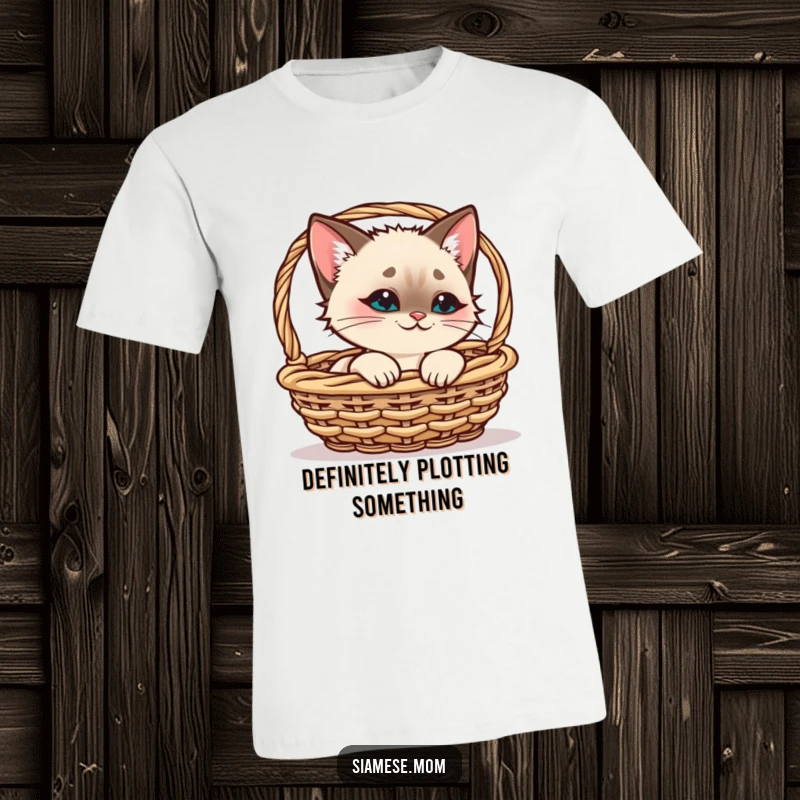 Funny Siamese Cat T-Shirt, kawaii cat peeking from a basket with a playful smirk, great for funny cat lover gifts.
