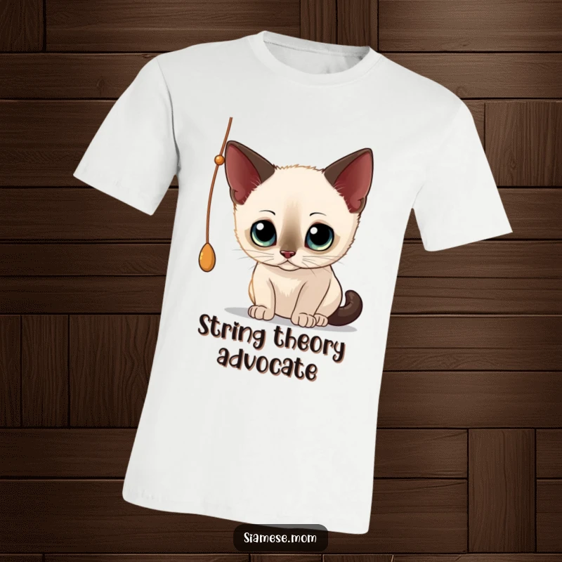 Funny Siamese Cat T-Shirt: Adorable cat with big eyes focused intently on a dangling string, showcasing playful curiosity.