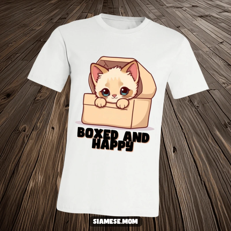 Funny Unisex T-Shirt: A kawaii Siamese kitten playfully peeking its head out from a tightly packed, soft, cardboard box.