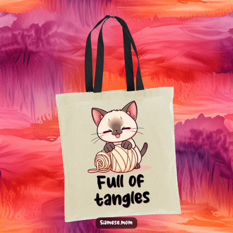 Funny Kawaii Siamese cat tote bag, playful smirk, pouncing on a rolled-up ball of yarn, a stylish and humorous accessory.