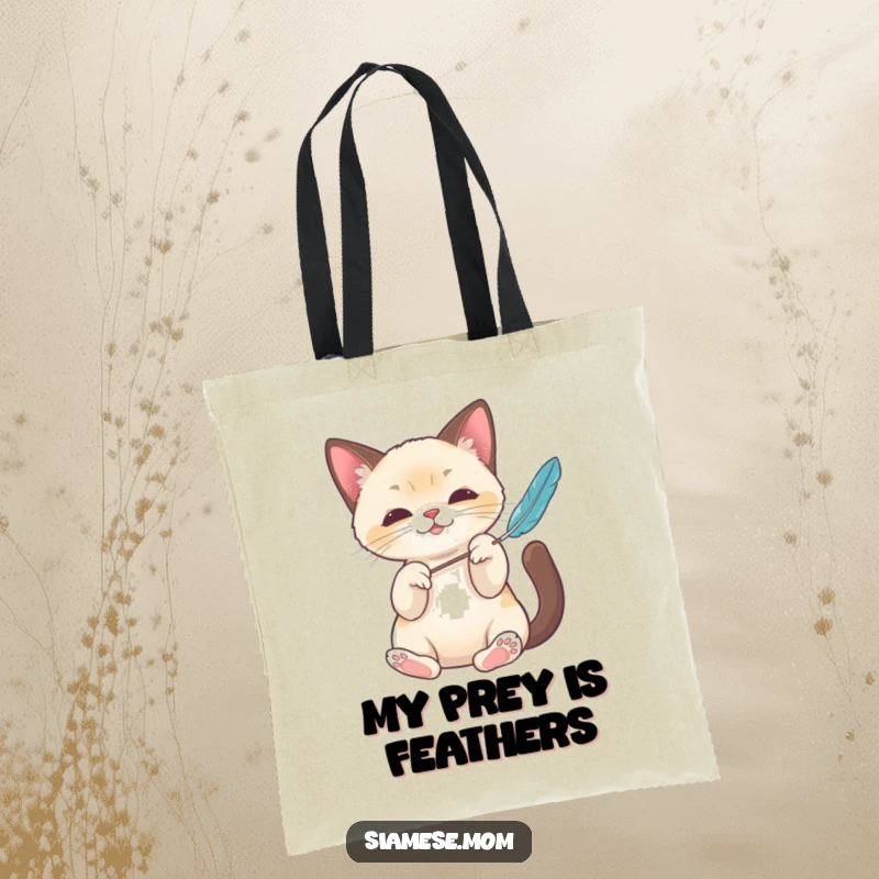 Funny Kawaii Siamese cat tote bag with elegant paws batting a feather toy, a stylish and humorous accessory for cat lovers.