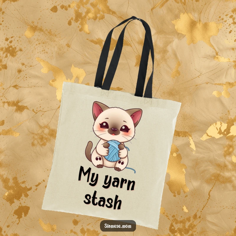 Funny tote bag featuring a kawaii Siamese cat playing with a ball of yarn, great for carrying essentials with feline flair.