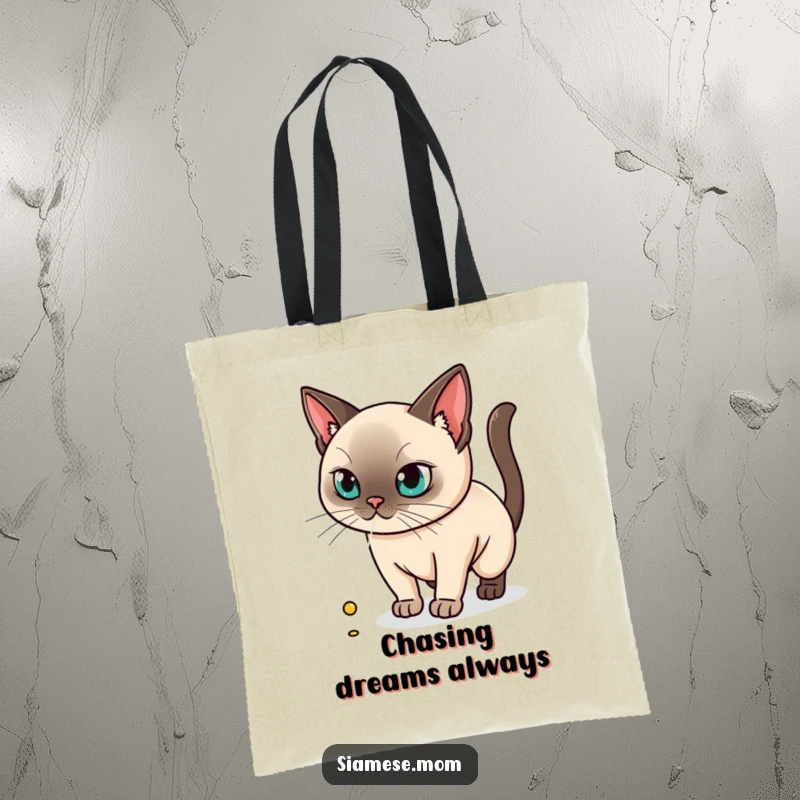 Funny tote bag design of a kawaii Siamese cat intently pursuing a tiny laser dot, full of playful energy.