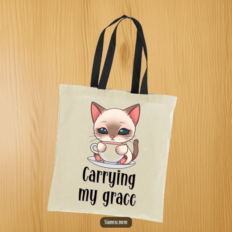 Cute tote bag with a kawaii Siamese cat sipping from a saucer, perfect for carrying items with feline charm.